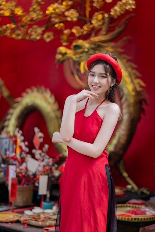 Young Woman Posing in a Traditional Red Ao Dai Dress