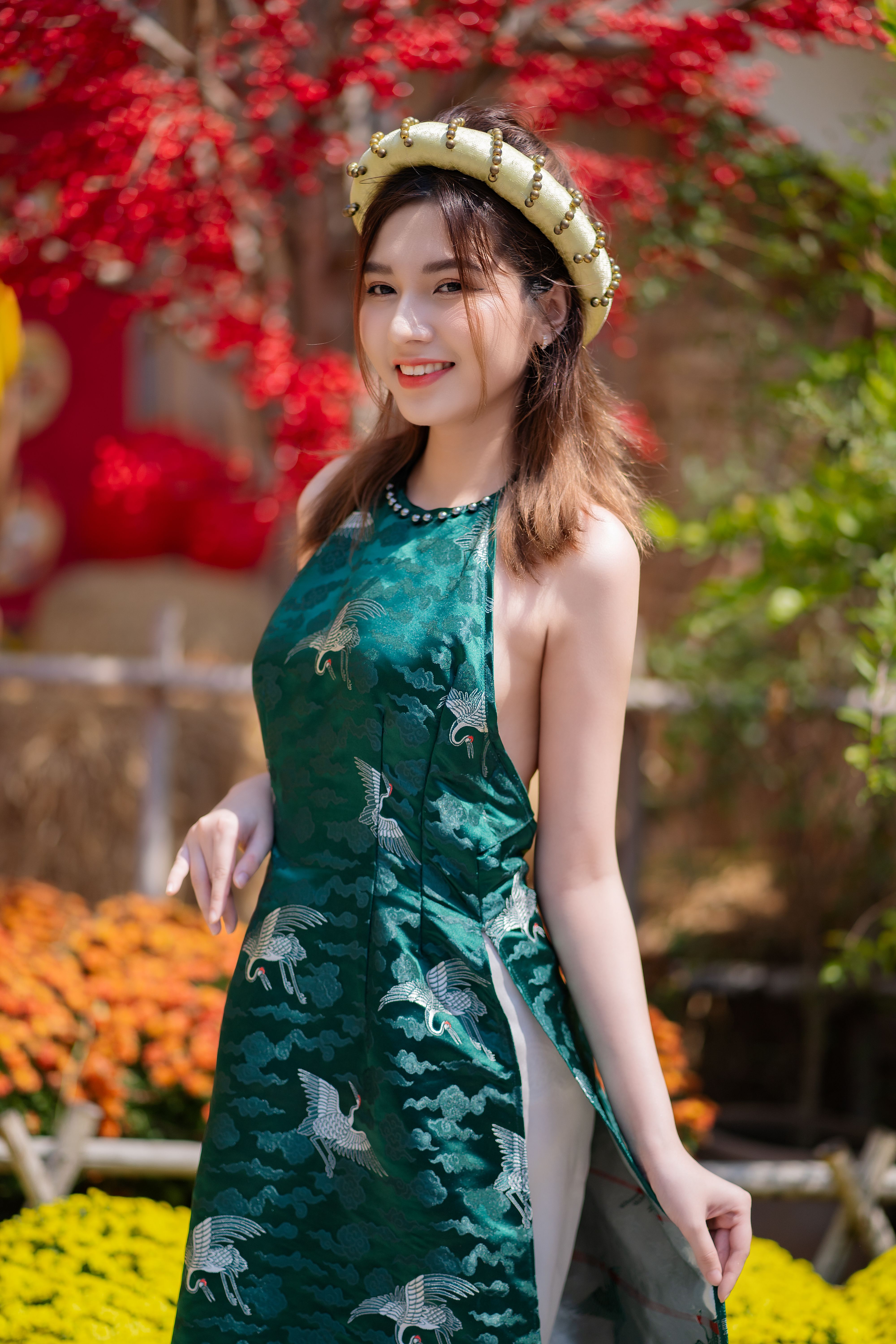 Young Woman Posing in a Traditional Green Ao Dai Dress  Free Stock Photo