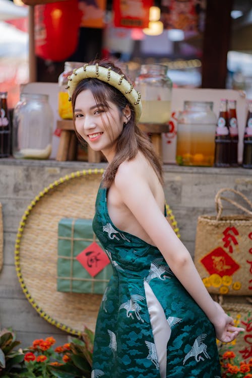 A woman in a green dress posing for a photo