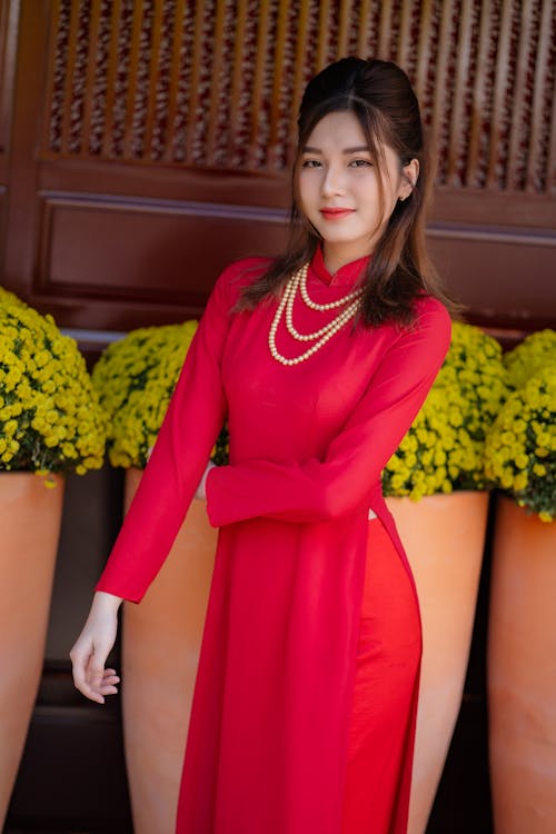 Young Woman Posing in a Traditional Red Ao Dai Dress