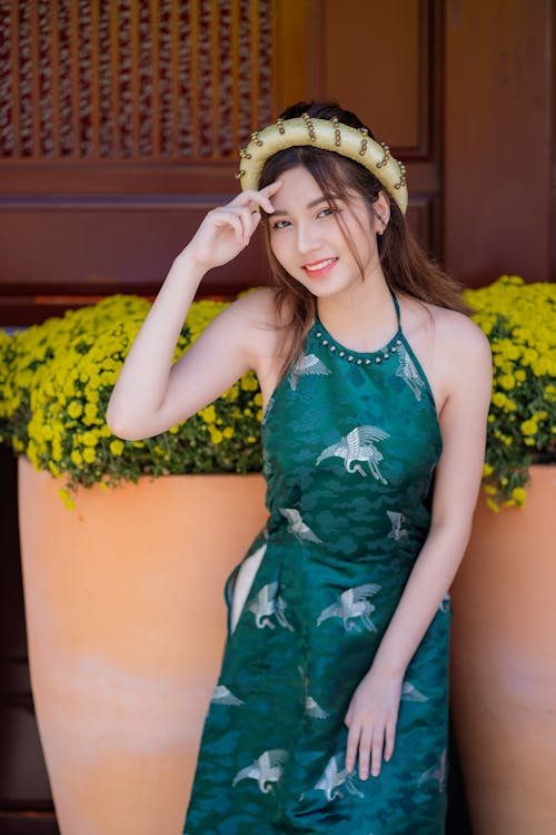 Young Woman Posing in a Traditional Green Ao Dai Dress