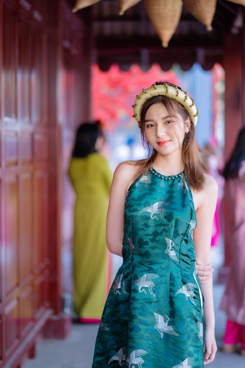 Young Woman Posing in a Traditional Green Ao Dai Dress