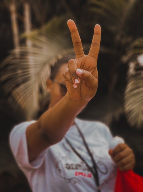 Close-up of a Woman Showing a Peace Sign 