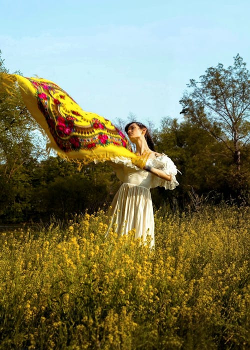 women showering the scarf in Mustard fields 