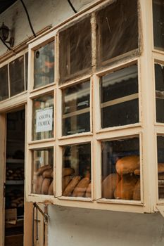 Exterior view of a bakery with fresh bread in window display.