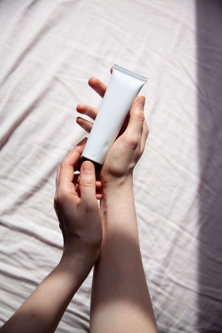 Woman Hands Holding Cosmetic Tube