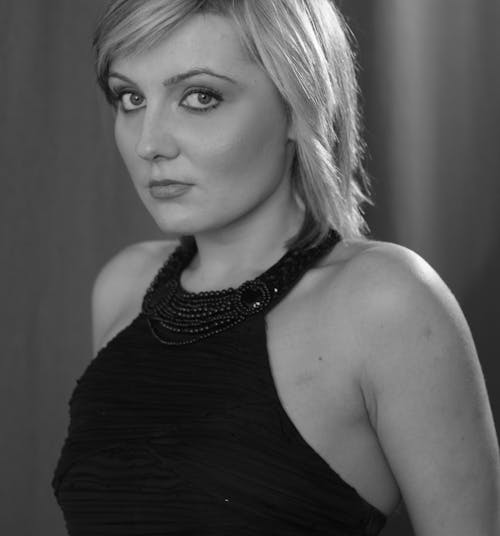 A woman with short blond hair posing for a black and white photo