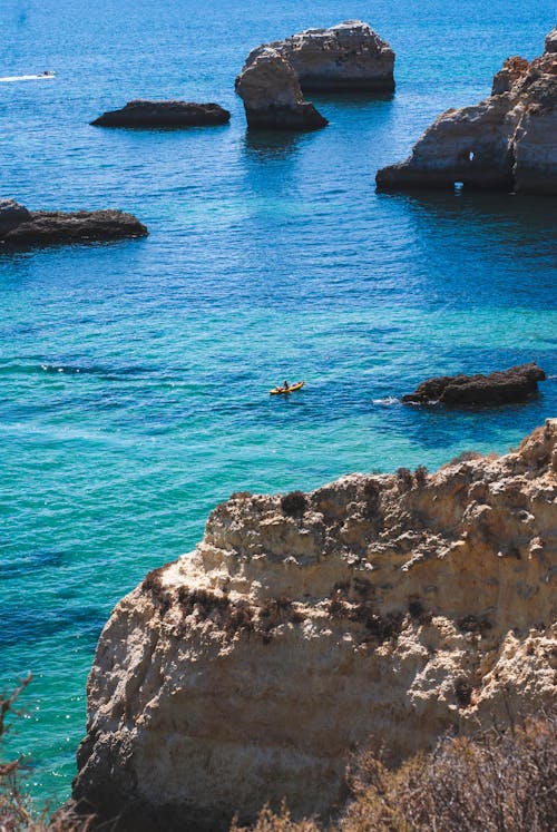 A view of the ocean with rocks and blue water