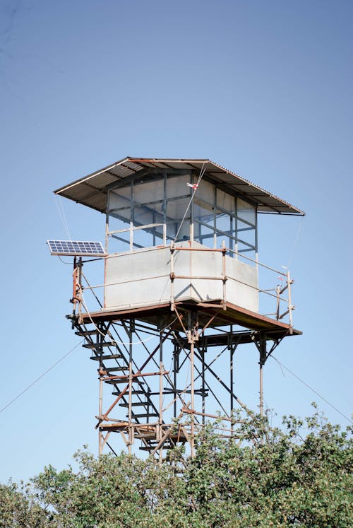 A guard tower with a solar panel on top