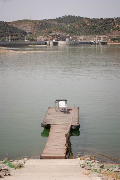 Chair and Table on Wooden Platform on Lake