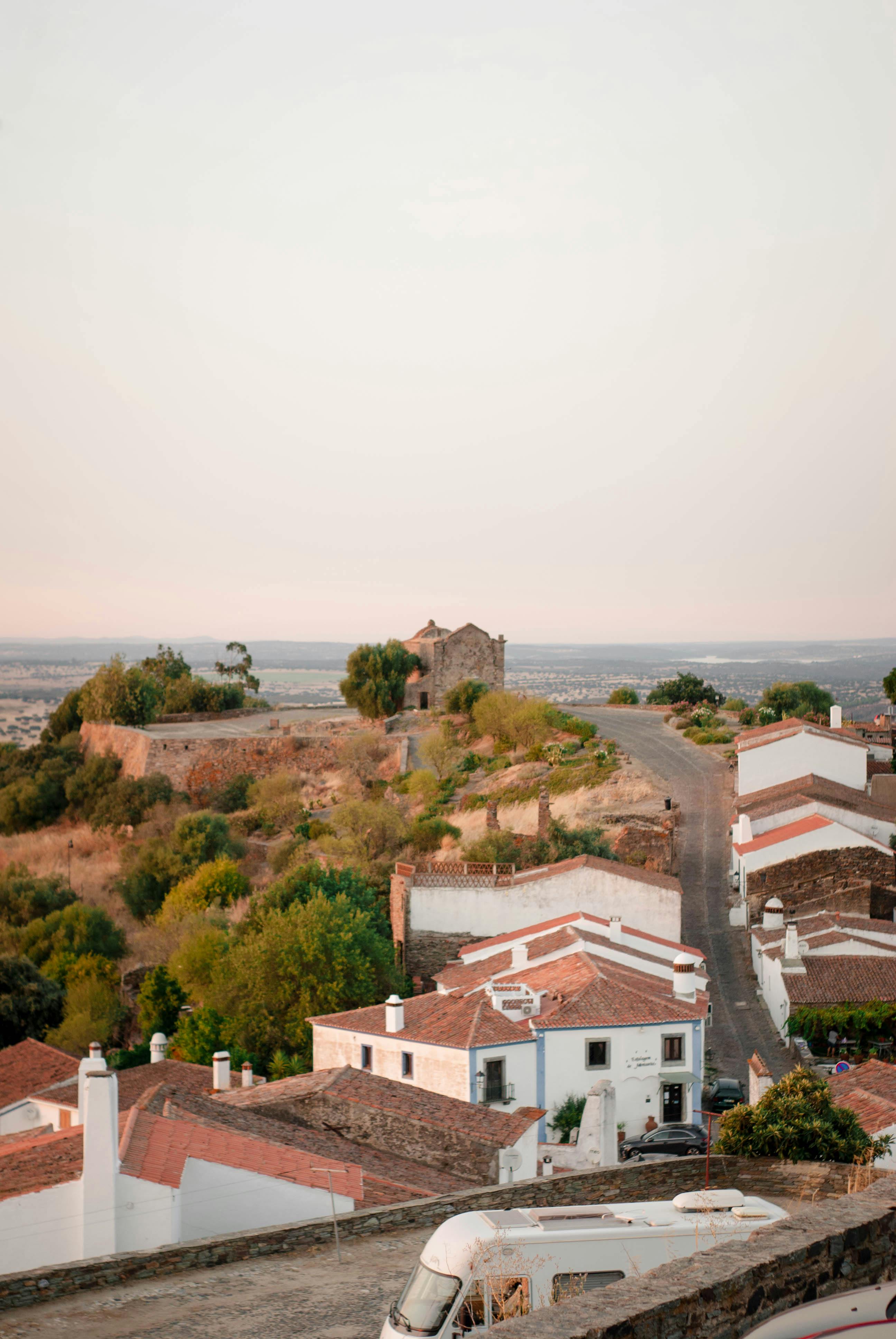 A picturesque aerial view of a historical village with charming houses and a hillside backdrop.