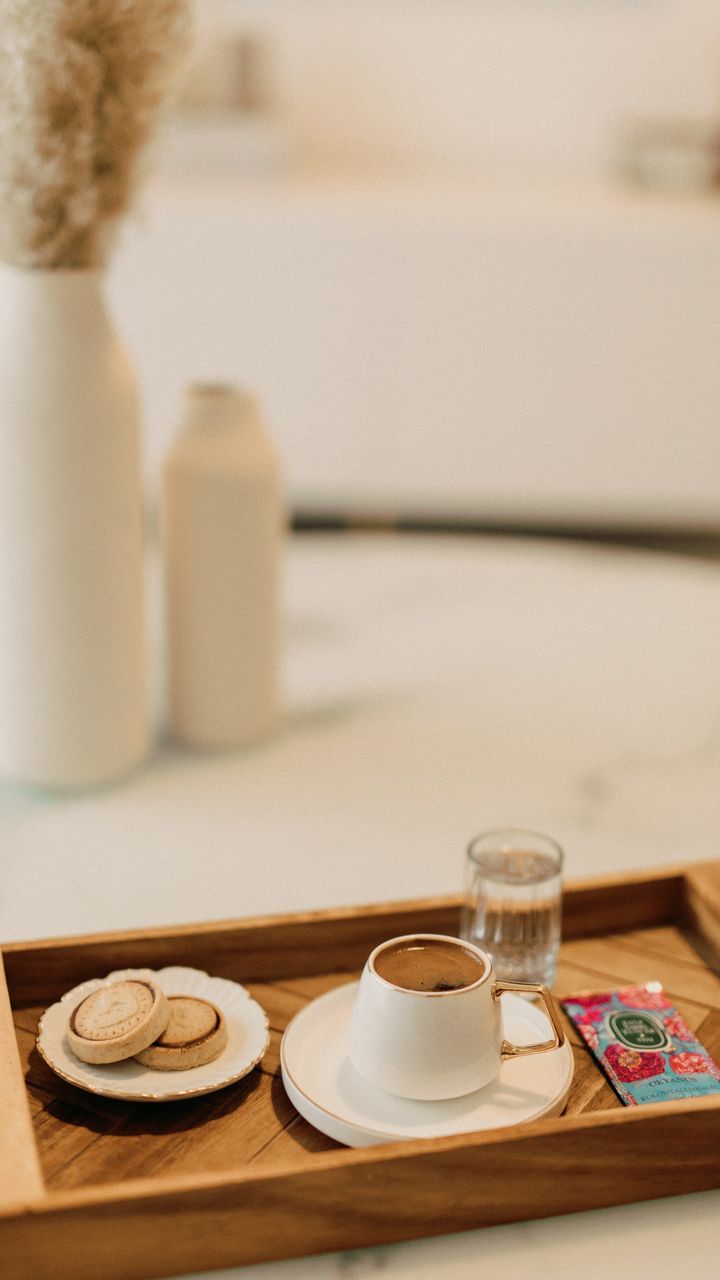 light wooden coffee tray holding two mugs and a small creamer pitcher
