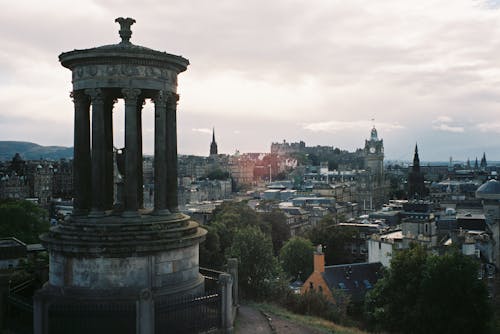 Free View of the Dugald Stewart Monument and Cityscape of Edinburgh, Scotland, UK  Stock Photo