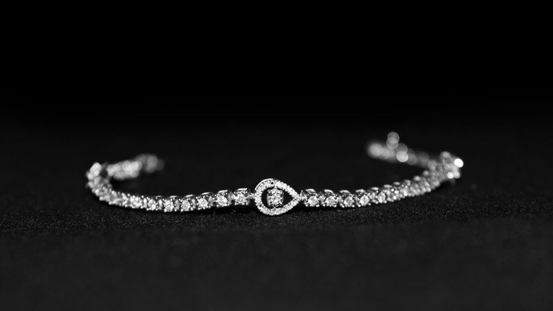 Close-up of a luxurious diamond bracelet with a black backdrop