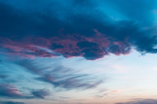 Free A vibrant and dramatic sunset featuring colorful clouds against a bright sky. Stock Photo