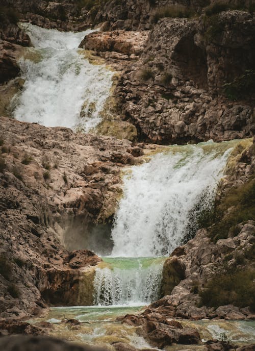 A waterfall is shown in the middle of a rocky area