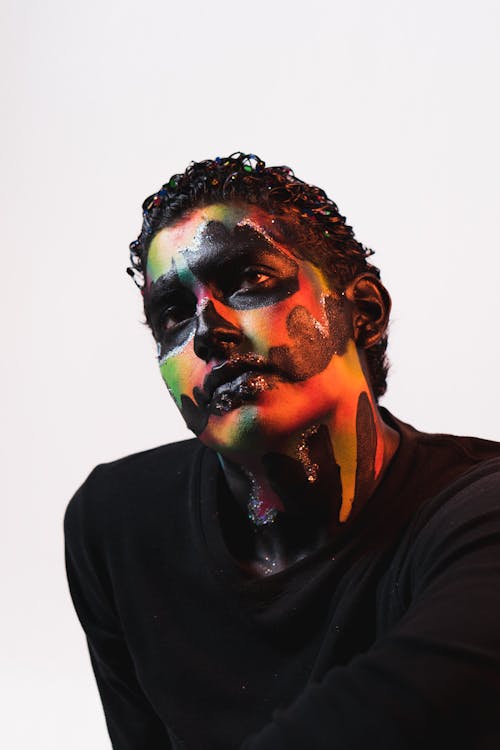 A man with face paint and black shirt