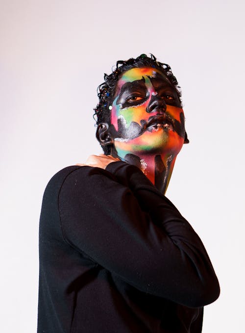 A man with colorful face paint on his body