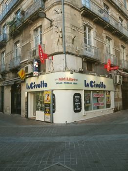 Corner store architecture on a vibrant city street in France.
