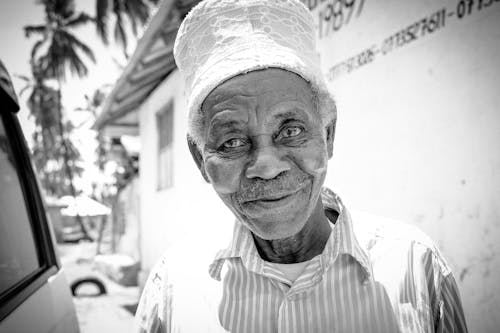 An old man wearing a turban and hat