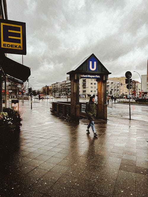 A person walking down a street in a rainy city