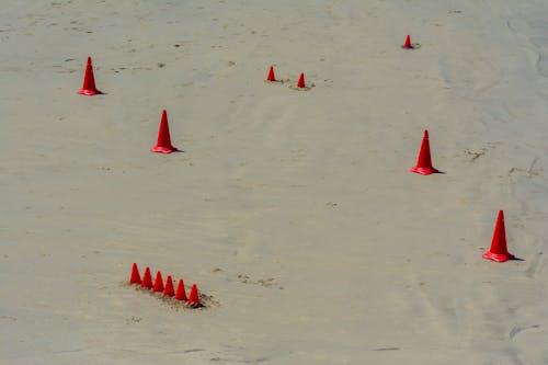 A group of red cones on the beach