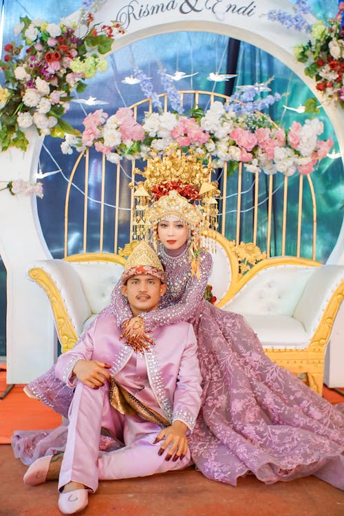 Newlyweds Sitting in Traditional Clothing