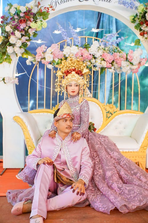 Newlyweds Sitting in Traditional Clothing