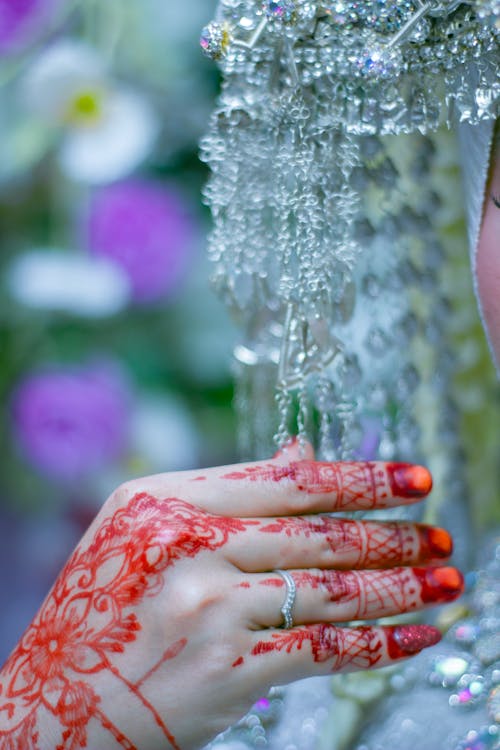 A bride with henna on her hands and face