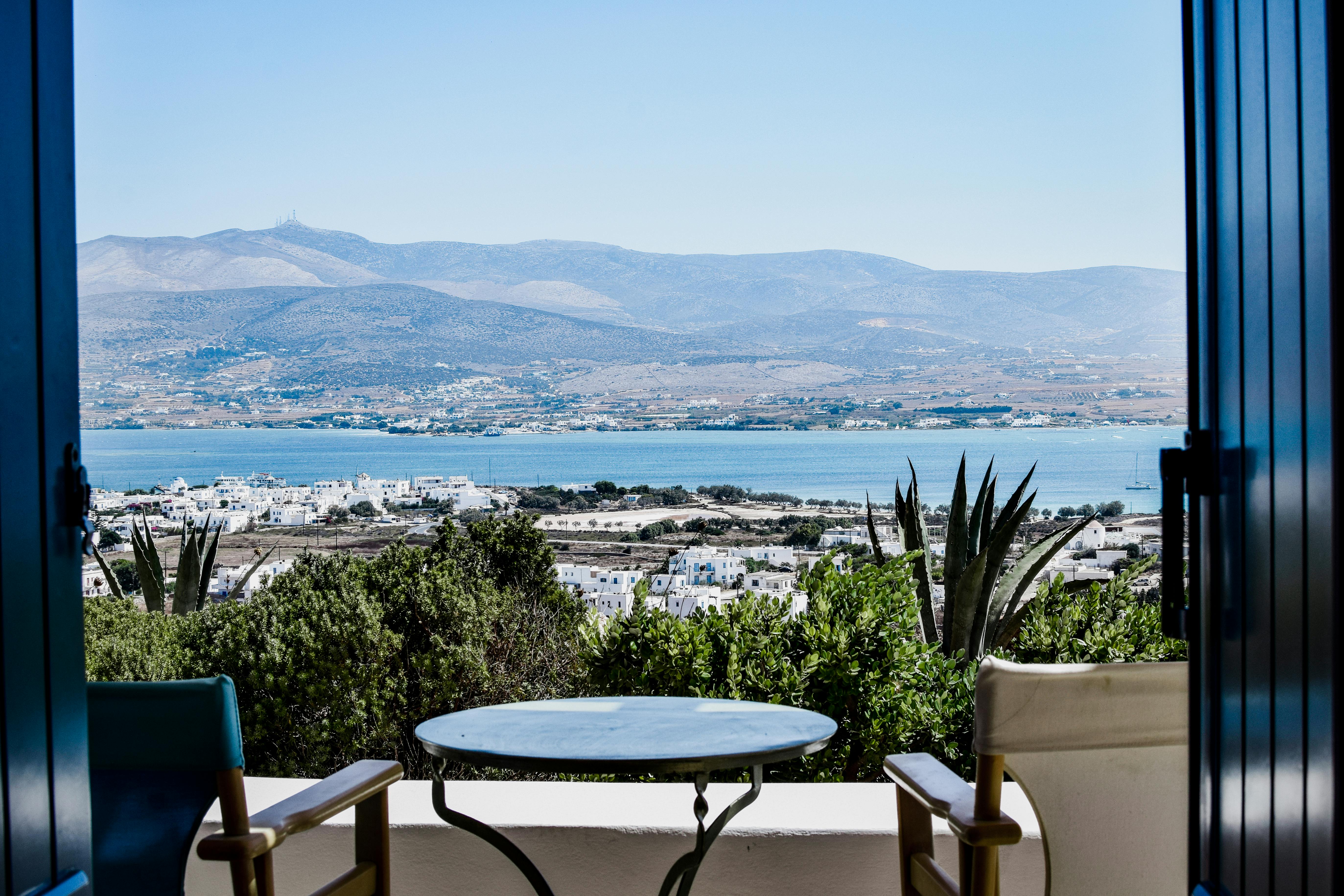 Folding Bistro Set On A Balcony With Plants And A City View