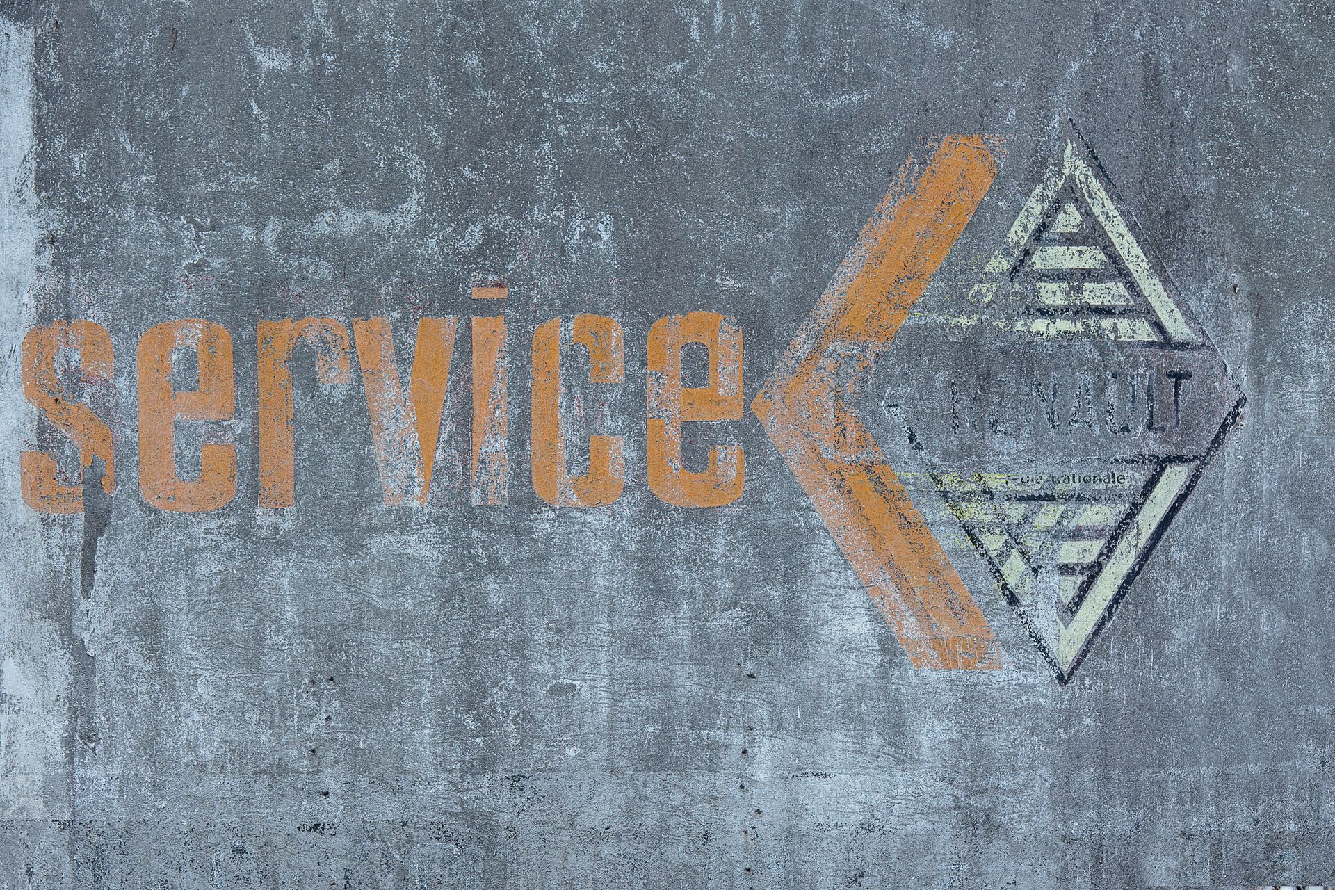 Wiped Text and Logo on Gray Wall