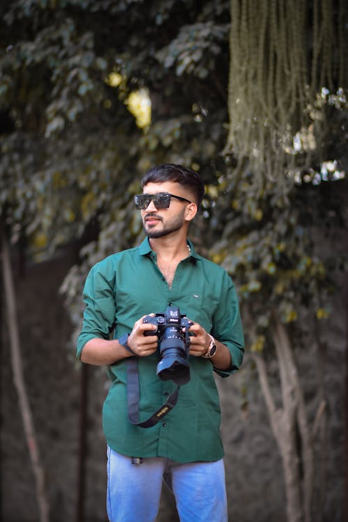 Man in Green Shirt and with Camera