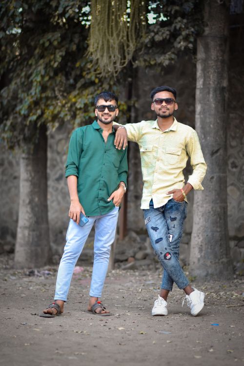 Free Two stylish men in casual attire pose outdoors with a relaxed vibe. Stock Photo