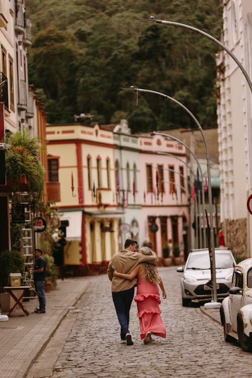 A couple walking down a cobblestone street