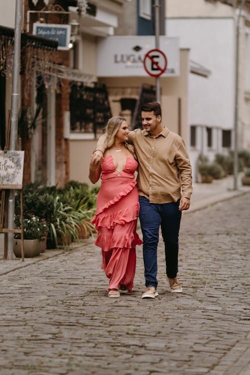 Couple Embracing and Walking on Street in Town