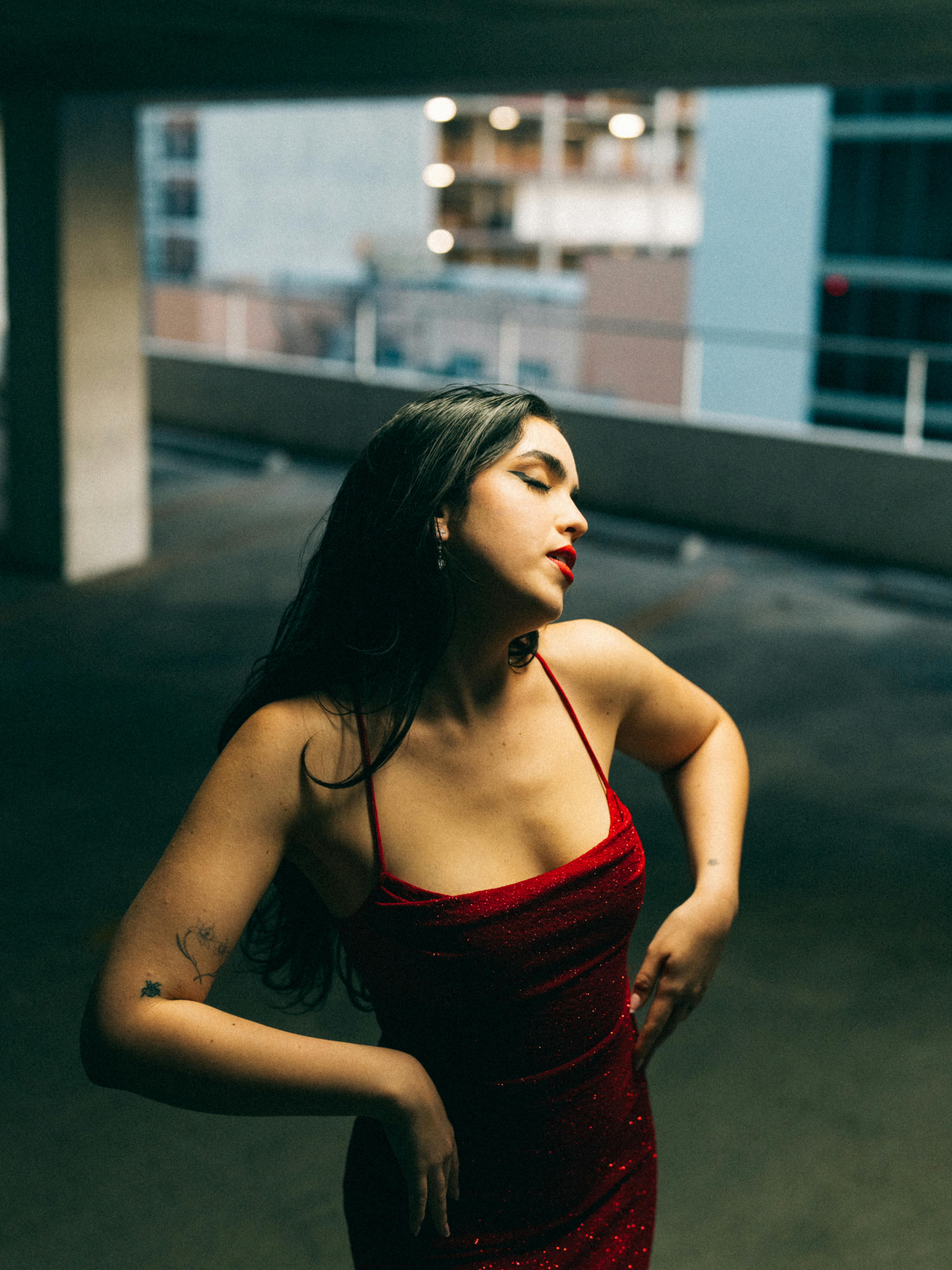 Free Portrait of Brunette Woman Wearing Red Dress on a Parking  Stock Photo