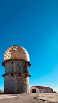 Vertical shot of Torre Meteorological Station with clear blue sky in Loriga, Portugal.