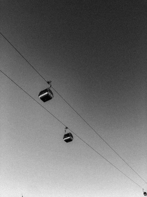 Black and white photo of two cable cars