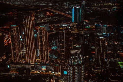Free A breathtaking aerial view of illuminated skyscrapers in an urban cityscape at night. Stock Photo