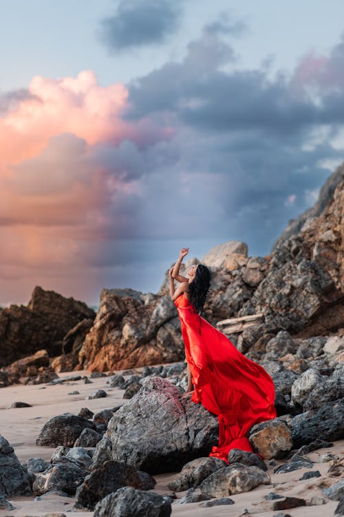 Brunette Woman in Red Dress on Beach