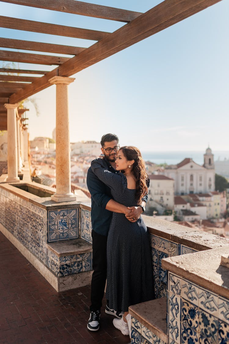 Couple Embracing On A Balcony