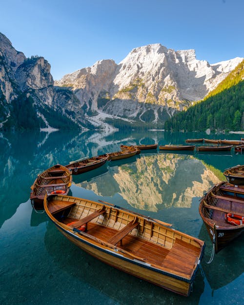 Boats in the lake with mountains in the background