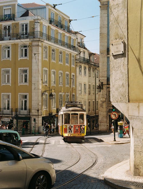 A trolley car is traveling down a street