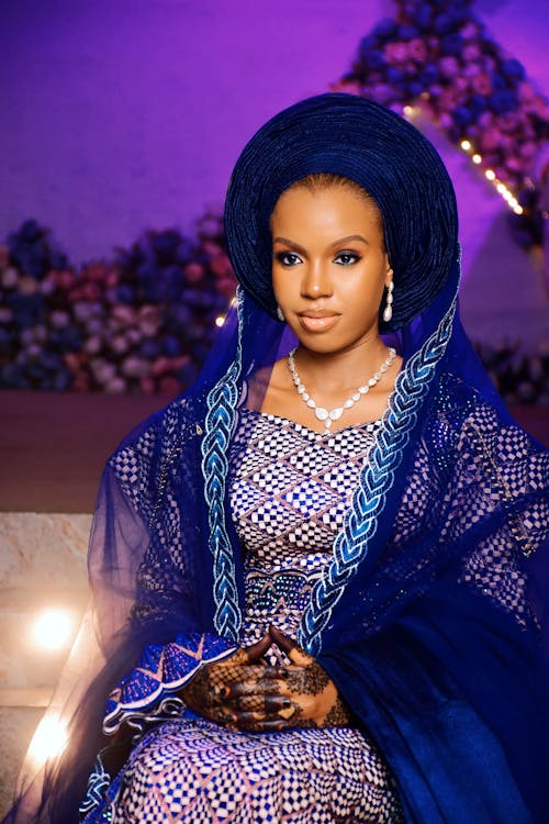 A beautiful woman in a blue dress and headpiece