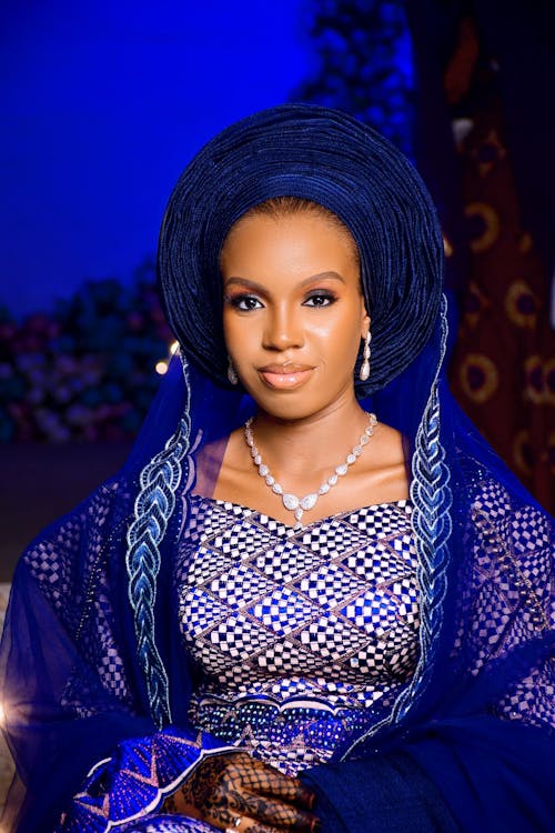 A beautiful woman in a blue dress and headpiece