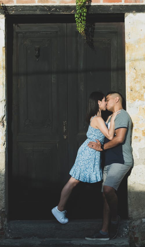 Woman in Sundress and Man Kissing