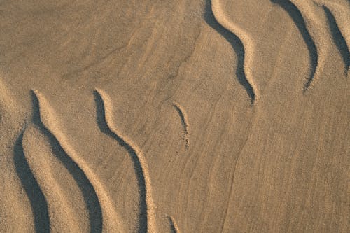 Sand dunes with waves in the background