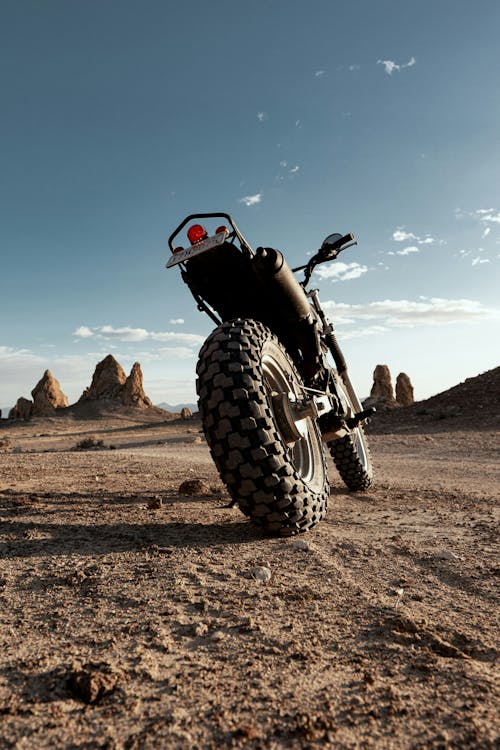 A motorcycle is parked in the desert