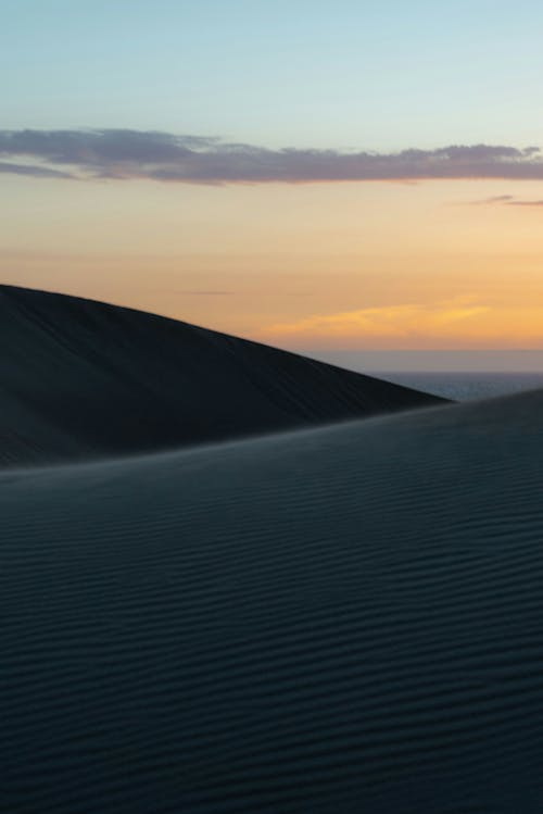 A sunset over the dunes in the desert