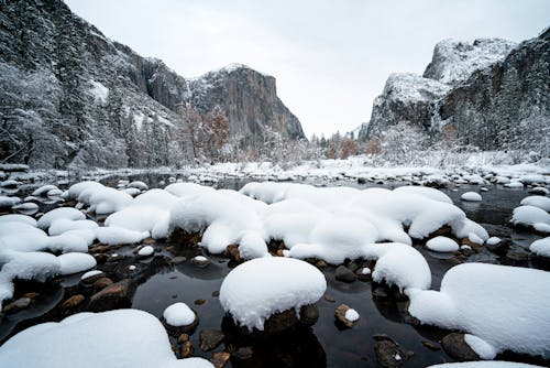 Snow covered rocks and water in yosemite valley